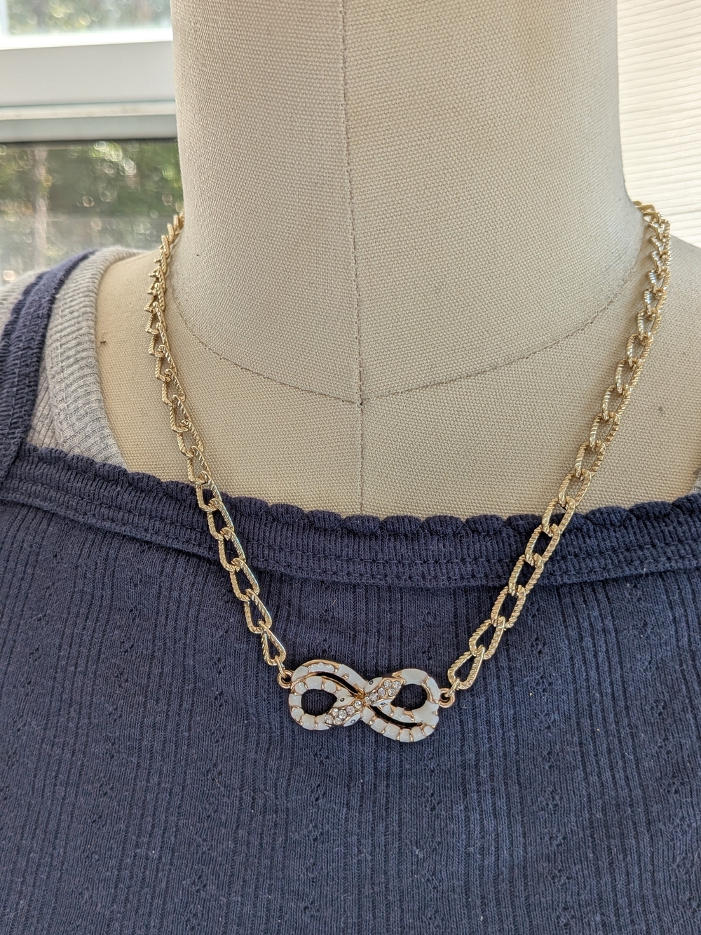 Gold Tone Infinity Pendant Necklace with White Inlay